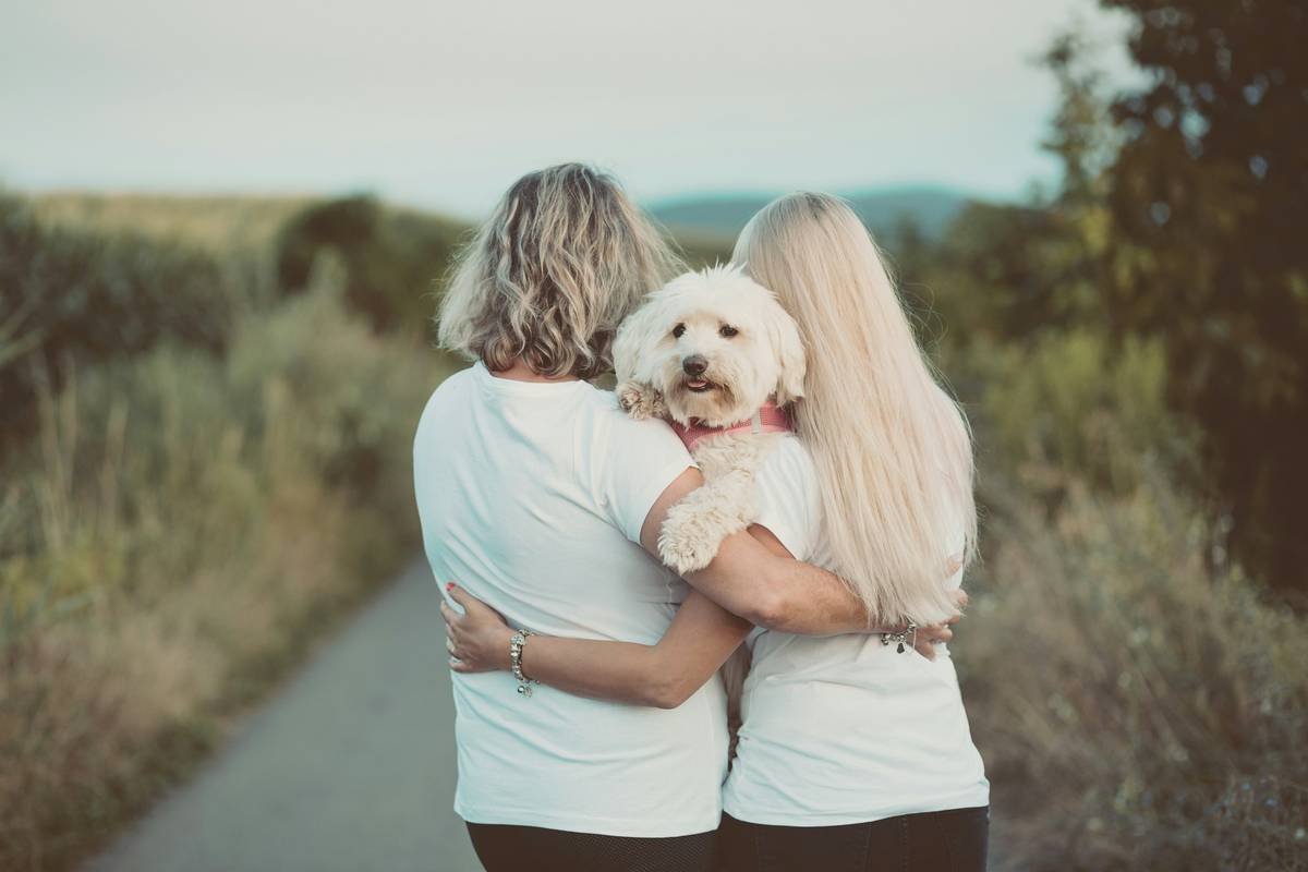 A handler hugging her guide dog at a bonding event.